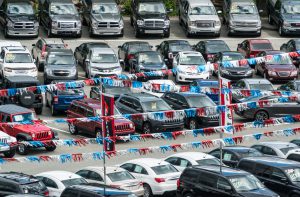Halifax, Canada - June 20, 2014: Looking down onto a car dealership featuring a wide variety of vehicles ranging from compact sedans to full size pickup trucks.