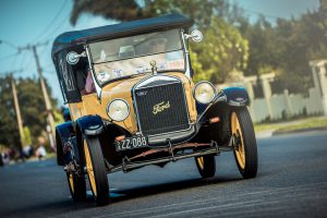 Adelaide, South Australia - September 28, 2014: Old Ford T car with people on board is driving on the street during the Bay to Birdwood car run.